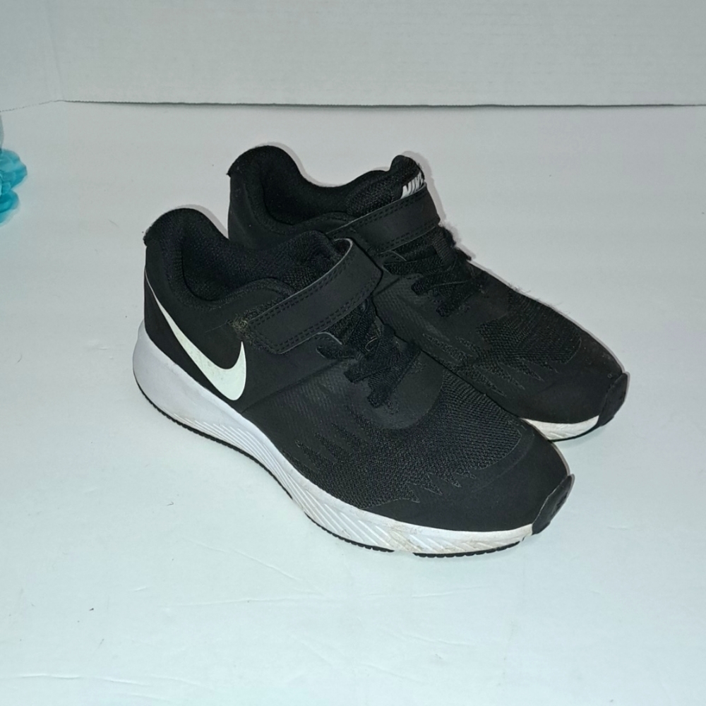 Nike, boys tennis shoe. BLACK WITH WHITE TRIM AND NIKE SIGN. CLEAN, WORN ONCE.